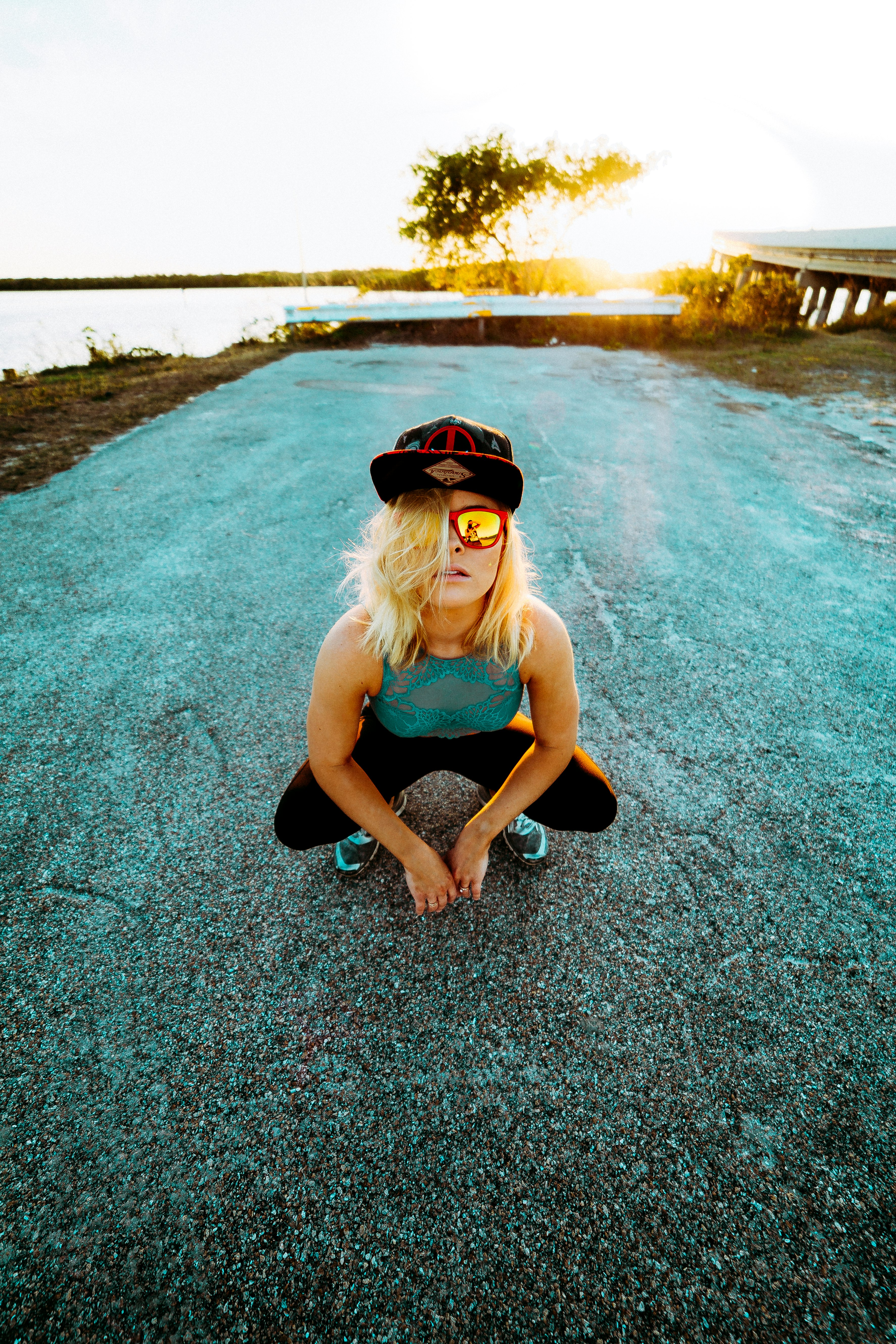 woman in blue sleeveless having picture during sunset